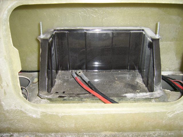 Battery box and bespoke cabling visible through access panel in bulkhead