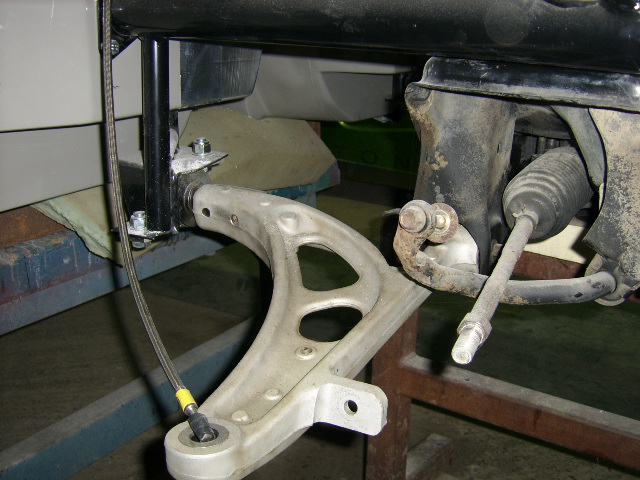 Alloy front wishbone and steering rack awaiting upright and calliper